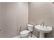 Clean bathroom with toilet and pedestal sink at 10232 Meandering Dell Ave, Las Vegas, NV 89166