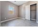 Bright bedroom with large window, tile flooring, and closet at 10232 Meandering Dell Ave, Las Vegas, NV 89166