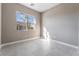 Well-lit bedroom with a window and tile flooring at 10232 Meandering Dell Ave, Las Vegas, NV 89166