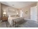 Main bedroom with neutral decor, plush bed, and wooden nightstands at 10232 Meandering Dell Ave, Las Vegas, NV 89166