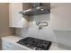 Modern kitchen with stainless steel range hood and pot filler at 10232 Meandering Dell Ave, Las Vegas, NV 89166