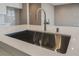 Modern kitchen with farmhouse sink and stainless steel faucet at 10232 Meandering Dell Ave, Las Vegas, NV 89166