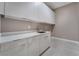 Laundry room with white cabinets and countertop at 10232 Meandering Dell Ave, Las Vegas, NV 89166