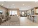 Open living room and kitchen with modern island, recessed lighting, and neutral colors at 10232 Meandering Dell Ave, Las Vegas, NV 89166