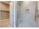 Walk-in shower with tiled walls and built-in seat at 10232 Meandering Dell Ave, Las Vegas, NV 89166