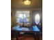 Dining area with wooden table, chairs and lace curtains at 1708 Weeping Willow Ln, Las Vegas, NV 89104