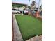 Artificial turf lawn with brick border and carport at 1708 Weeping Willow Ln, Las Vegas, NV 89104