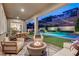 Outdoor entertainment area with pool, fire pit, and seating at 6411 Wild Blue Ct, Las Vegas, NV 89135