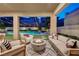 Relaxing patio with fire pit and pool views at 6411 Wild Blue Ct, Las Vegas, NV 89135