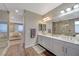 Modern bathroom with double vanity, walk in shower, and plenty of light at 6411 Wild Blue Ct, Las Vegas, NV 89135