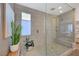 Spa-like bathroom with a large walk-in shower and pebble floor at 6411 Wild Blue Ct, Las Vegas, NV 89135