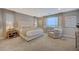 Spacious primary bedroom with plush bed, large windows and seating area at 6411 Wild Blue Ct, Las Vegas, NV 89135