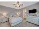 Main bedroom with a ceiling fan and en-suite bathroom access at 6411 Wild Blue Ct, Las Vegas, NV 89135