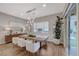 Bright dining room with a rustic wood table and modern lighting at 6411 Wild Blue Ct, Las Vegas, NV 89135