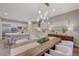 Open concept dining room with kitchen island and modern light fixture at 6411 Wild Blue Ct, Las Vegas, NV 89135