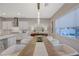 Modern farmhouse dining room with a long wooden table and white chairs at 6411 Wild Blue Ct, Las Vegas, NV 89135