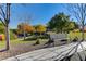 Metal park bench sits beneath trees in a well-manicured park setting at 6411 Wild Blue Ct, Las Vegas, NV 89135