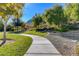 Paved pathway meanders through a lush green park area at 6411 Wild Blue Ct, Las Vegas, NV 89135