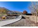 Curving concrete pathway winds through a landscaped park with a scenic backdrop at 6411 Wild Blue Ct, Las Vegas, NV 89135