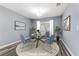 Virtually staged dining area with modern table and chairs at 8774 Libertyvale Dr, Las Vegas, NV 89123