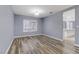 Bright dining room with wood-look floors and large window at 8774 Libertyvale Dr, Las Vegas, NV 89123