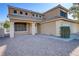 Two-story house with beige exterior and landscaping at 8774 Libertyvale Dr, Las Vegas, NV 89123