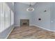 Gathering room with stone fireplace and wood-look floors at 8774 Libertyvale Dr, Las Vegas, NV 89123