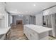 Modern kitchen island with white cabinets and view to Gathering room at 8774 Libertyvale Dr, Las Vegas, NV 89123