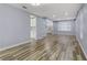 Open living room with wood-look floors and view to kitchen at 8774 Libertyvale Dr, Las Vegas, NV 89123