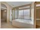 Spacious bathroom with a shower/tub combo and a large window at 2134 Eaglepath Cir, Henderson, NV 89074