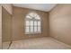 Bedroom with large window and mirrored closet doors at 2134 Eaglepath Cir, Henderson, NV 89074