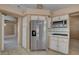 Modern kitchen with stainless steel refrigerator and white cabinets at 2134 Eaglepath Cir, Henderson, NV 89074