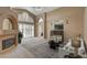 Bright living room featuring a fireplace and large windows at 2134 Eaglepath Cir, Henderson, NV 89074