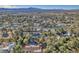 Community aerial view featuring lush trees, houses, neighborhood amenities, and mountain views in the background at 2868 Vista Del Sol Ave, Las Vegas, NV 89120