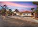 Gorgeous home with a three-car garage, lush landscaping, and brick-trimmed driveway at 2868 Vista Del Sol Ave, Las Vegas, NV 89120