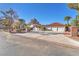 Charming home with brick-trimmed driveway, a three-car garage, and mature palm trees at 2868 Vista Del Sol Ave, Las Vegas, NV 89120