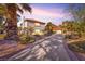 Well-manicured front yard with palm trees and landscaping leading to a charming home at 2868 Vista Del Sol Ave, Las Vegas, NV 89120