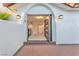 Modern front entrance with an arched entryway, stylish door, and updated lighting at 2868 Vista Del Sol Ave, Las Vegas, NV 89120