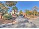 Inviting entrance with mature landscaping and a circular driveway leading to the home at 2868 Vista Del Sol Ave, Las Vegas, NV 89120