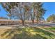 Exterior view of horse stables showing the paddock, lush grass, and arrangement of stalls in the surrounding community at 2868 Vista Del Sol Ave, Las Vegas, NV 89120