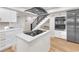 Modern kitchen with a cooking island, stainless steel appliances, and adjacent staircase at 2868 Vista Del Sol Ave, Las Vegas, NV 89120