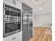 Modern kitchen appliances including stainless steel refrigerator and built-in double oven at 2868 Vista Del Sol Ave, Las Vegas, NV 89120