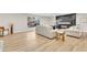 Open-concept living space with hardwood floors and a modern fireplace accent wall at 2868 Vista Del Sol Ave, Las Vegas, NV 89120