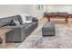 Cozy living room with a gray sofa, plush pillows, and an ottoman, with a pool table visible at 2868 Vista Del Sol Ave, Las Vegas, NV 89120