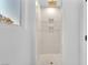 Modern shower featuring white tiling, niche, and gold hardware fixtures at 2868 Vista Del Sol Ave, Las Vegas, NV 89120