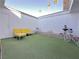 Private courtyard with artificial turf, yellow couch, and fountain at 3004 El Camino Ave, Las Vegas, NV 89102