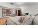 Bright and inviting bedroom with a cozy window-side sitting area and built-in shelving at 3841 Hildebrand Ln, Las Vegas, NV 89121