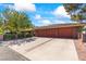 Spacious three-car garage with a long driveway and mature landscaping at 3841 Hildebrand Ln, Las Vegas, NV 89121