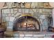 Unique stone fireplace with glass doors and decorative accents creates a cozy atmosphere at 3841 Hildebrand Ln, Las Vegas, NV 89121