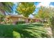 Beautiful brick home featuring lush green lawn and mature trees, adding to its curb appeal at 3841 Hildebrand Ln, Las Vegas, NV 89121